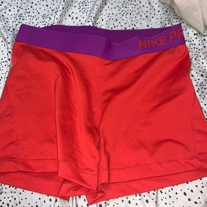 red and purple nike pro shorts, size medium